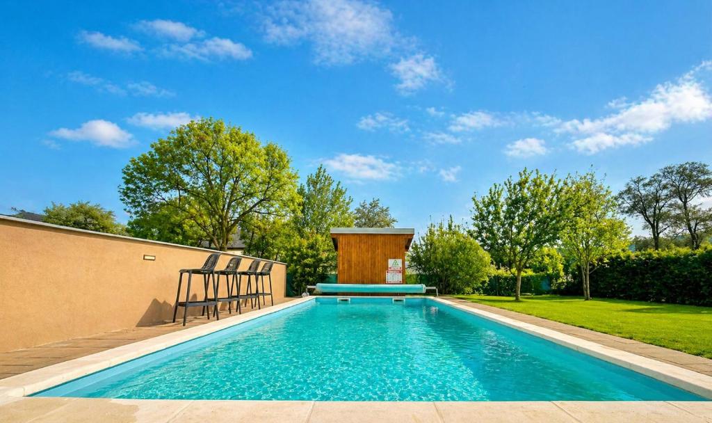 a swimming pool in the backyard of a house at Holiday home Melani - with private heated pool and sauna in Sinac
