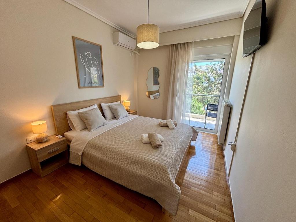 a bedroom with a bed with two towels on it at Alimos Signature in Athens