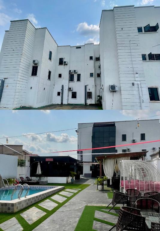 a large white building with a pool in front of it at Montevar Hotel in Benin City