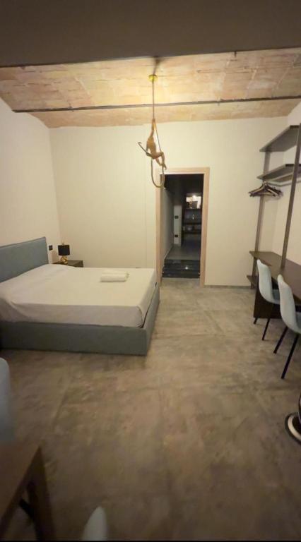 a bedroom with a bed and chairs in a room at Alloggio del Trap in Ferentillo