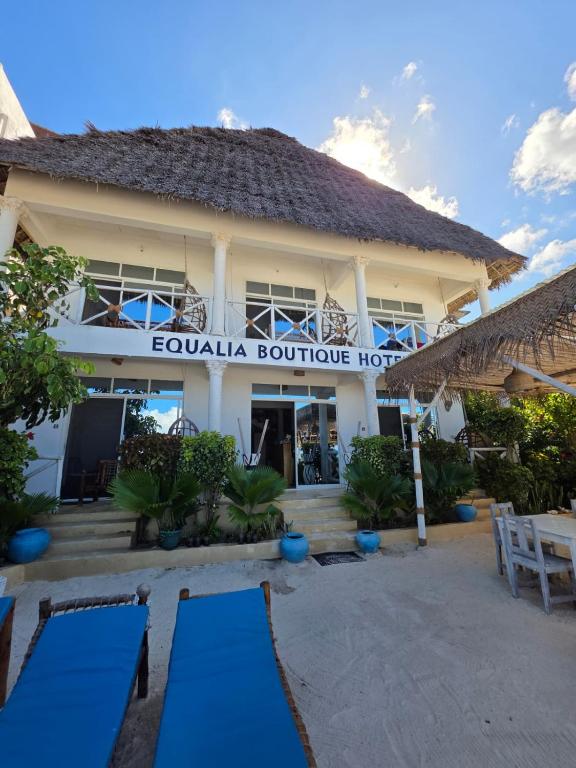 a building with a sign for the equila boutique hotel at Equalia boutique hotel in Jambiani