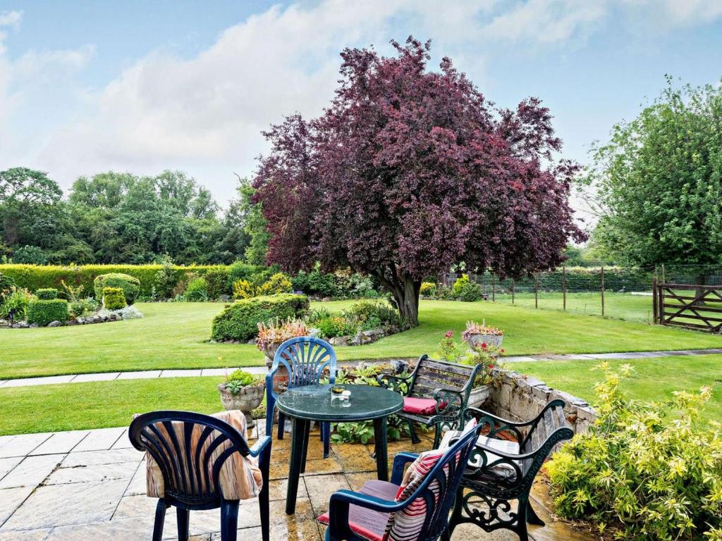 a patio with chairs and a table in a garden at 2 Bed in Spalding oc-83540 in Donington