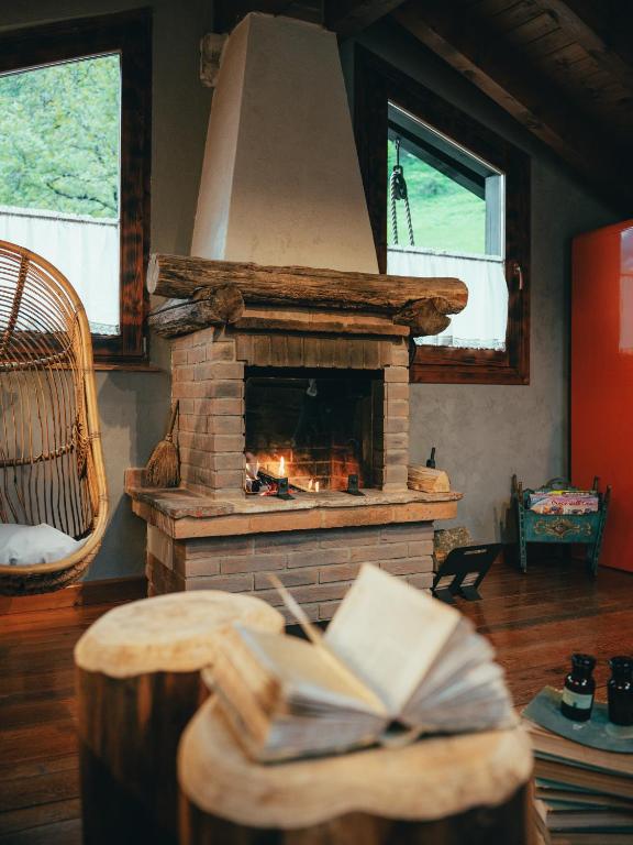 a fireplace in a living room with a book on a table at La Bottega del Drago in Santa Brigida