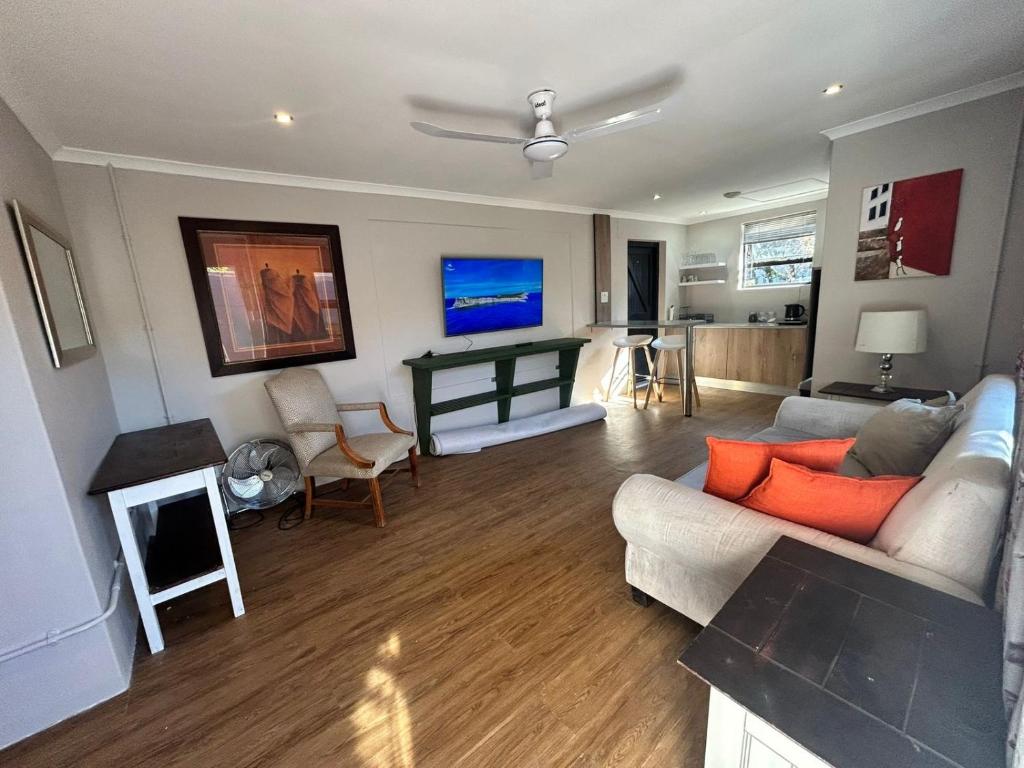 a living room with a couch and a fireplace at Meerlust Cottage in Cape Town