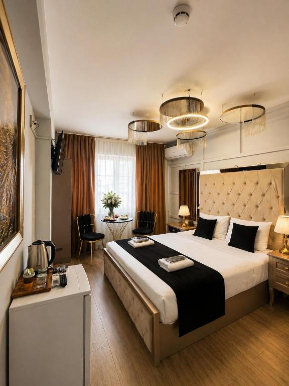 a bedroom with a large bed and a living room at Luka Suit Hotel in Istanbul