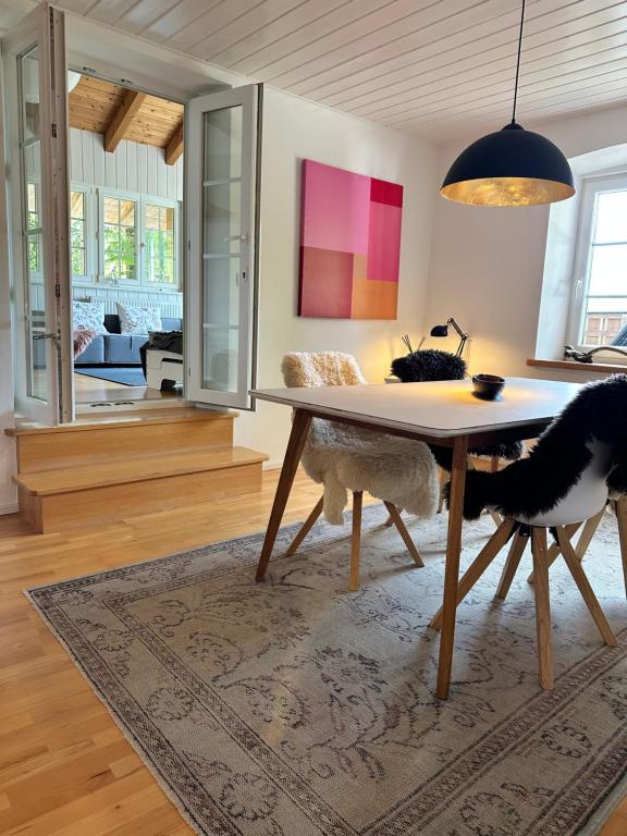a living room with a table and a couch at Design-Apartment am Wildbach mit Bergblick & direktem Zugang zur Natur in Fischbachau