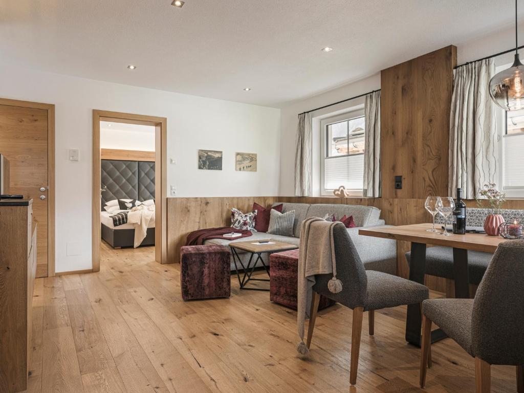 a living room with a couch and a table at Landhaus Mader Hintertux in Tux