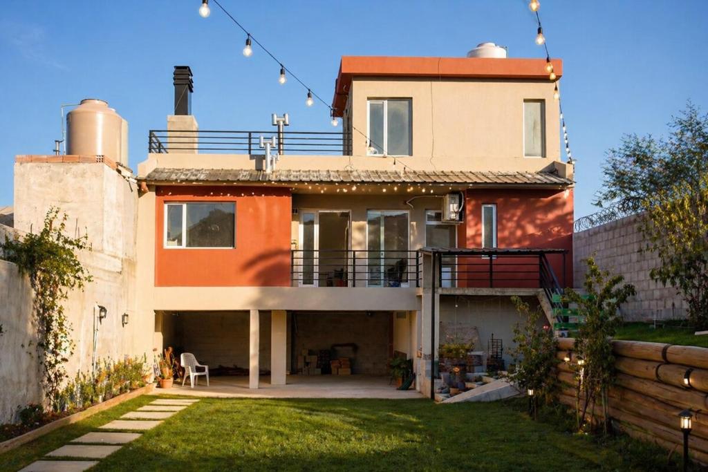 a large house with a fence in front of it at Casa Juanca in Comodoro Rivadavia