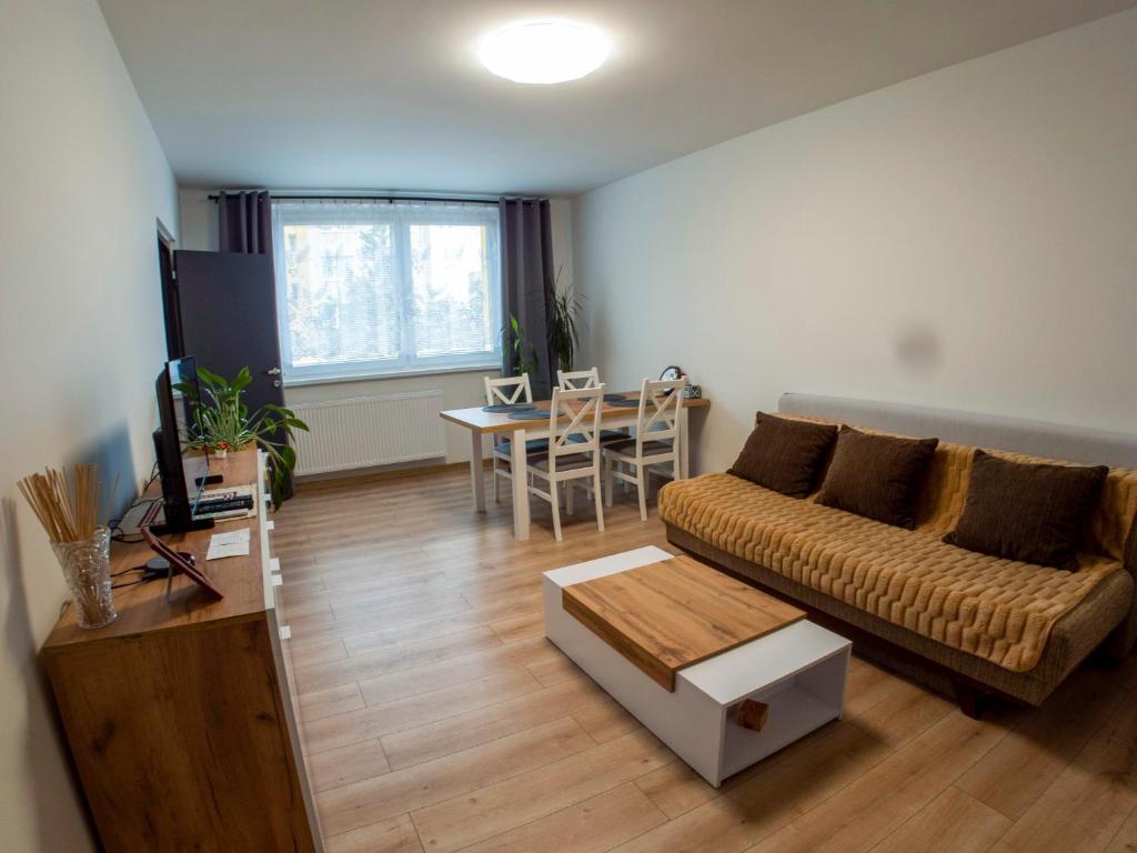 a living room with a couch and a table at Apartmán Gerlach in Vyšné Hágy