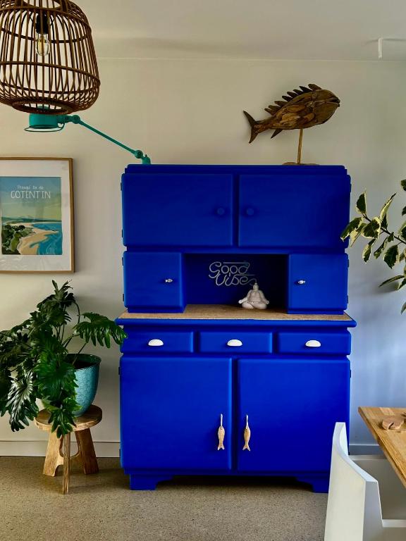 a stack of blue dressers in a room at Etoile du Kap in Barneville-Carteret