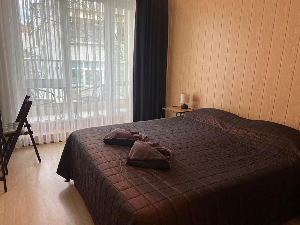 a bedroom with a bed with a robe on it at KiShouse in Burgas