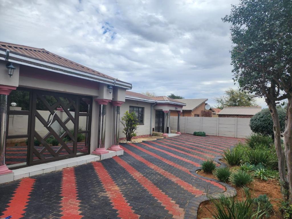 a house with a red brick driveway at PJ Guesthouse in Welkom