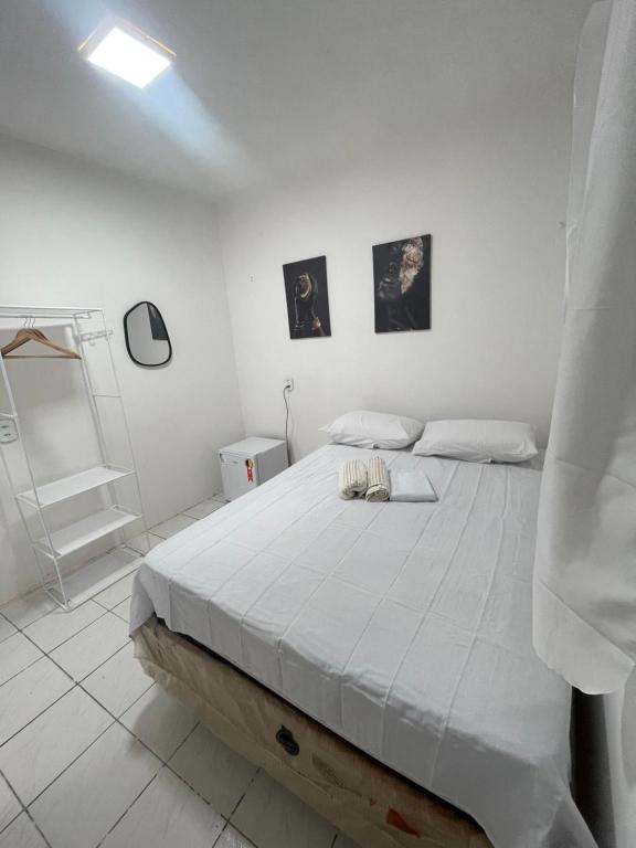 a white bedroom with a large bed in it at Hospedagem Sousa in Santa Inês