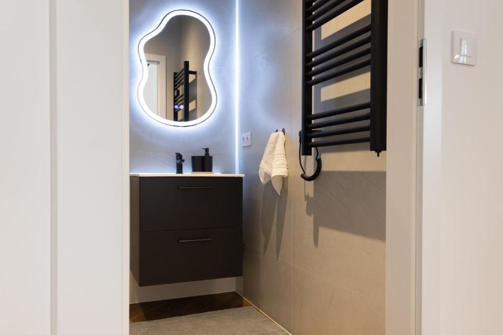 a bathroom with a sink and a mirror at Starowiejska Residence 1860 A in Miejsce Piastowe