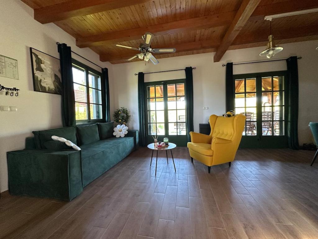 a living room with a green couch and a yellow chair at Green river cottage in Žažina