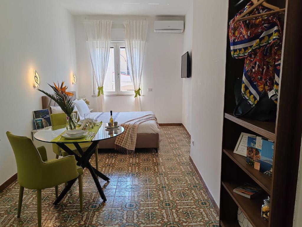 a small room with a table and a bed at Home Julia in Massa Lubrense