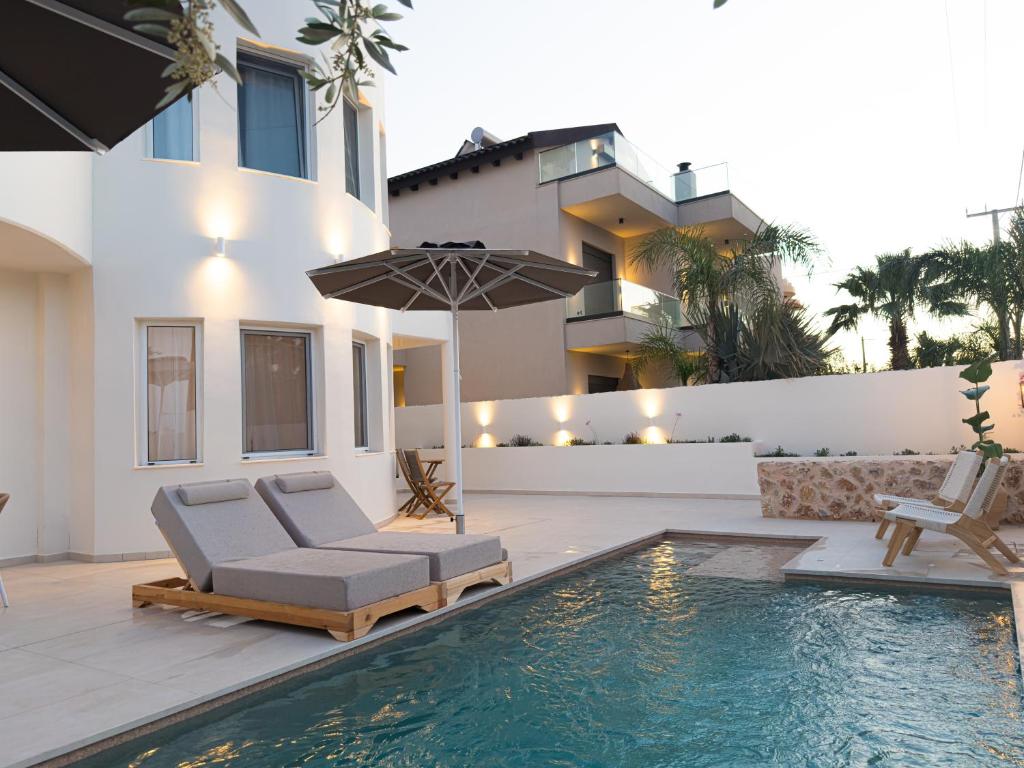 a villa with a swimming pool in front of a house at Villa Rhodea in Ialysos
