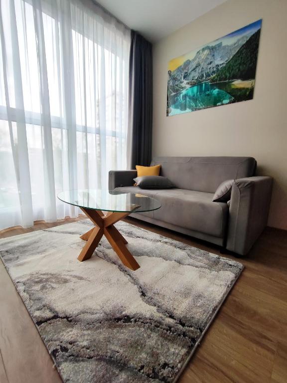 a living room with a couch and a coffee table at Apartment in Chantrer Residence with garage in Burgas