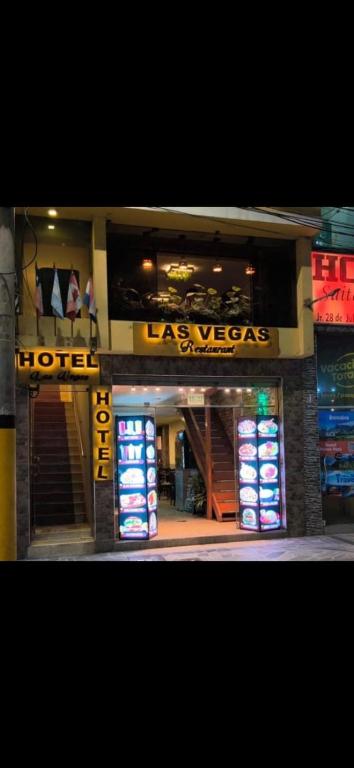 a store front with a sign for a hotel at Hotel las vegas in Huánuco
