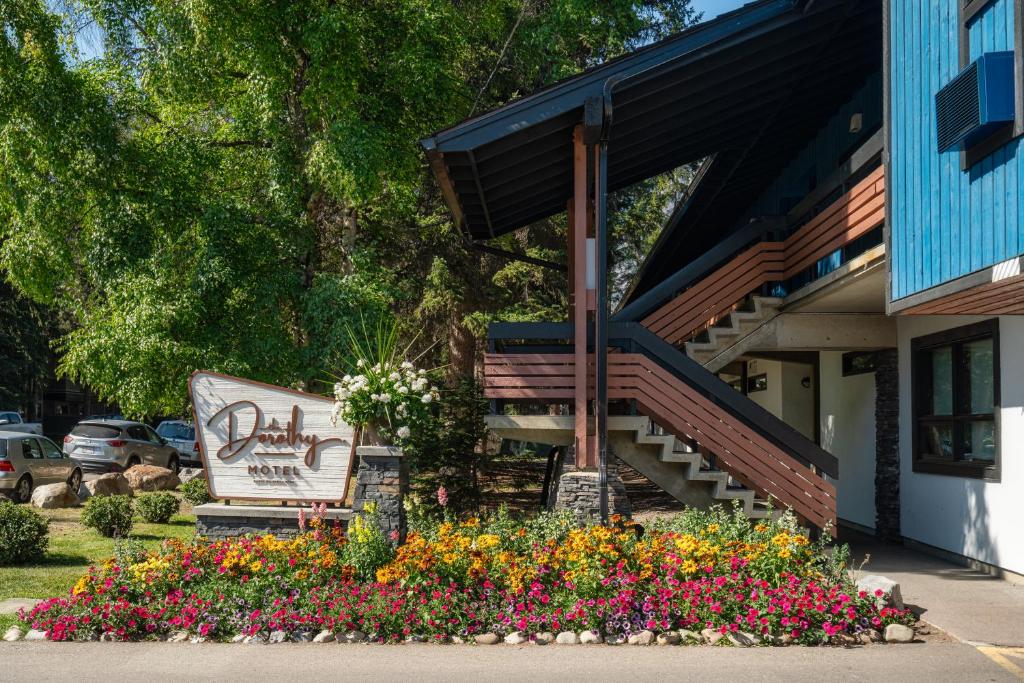 a building with a bunch of flowers in front of it at The Dorothy Motel in Banff