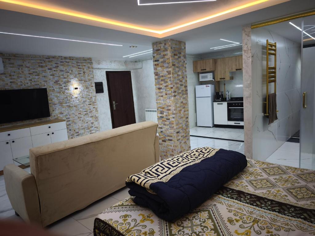 a living room with a couch and a kitchen at studio moderne in Tizi Ouzou
