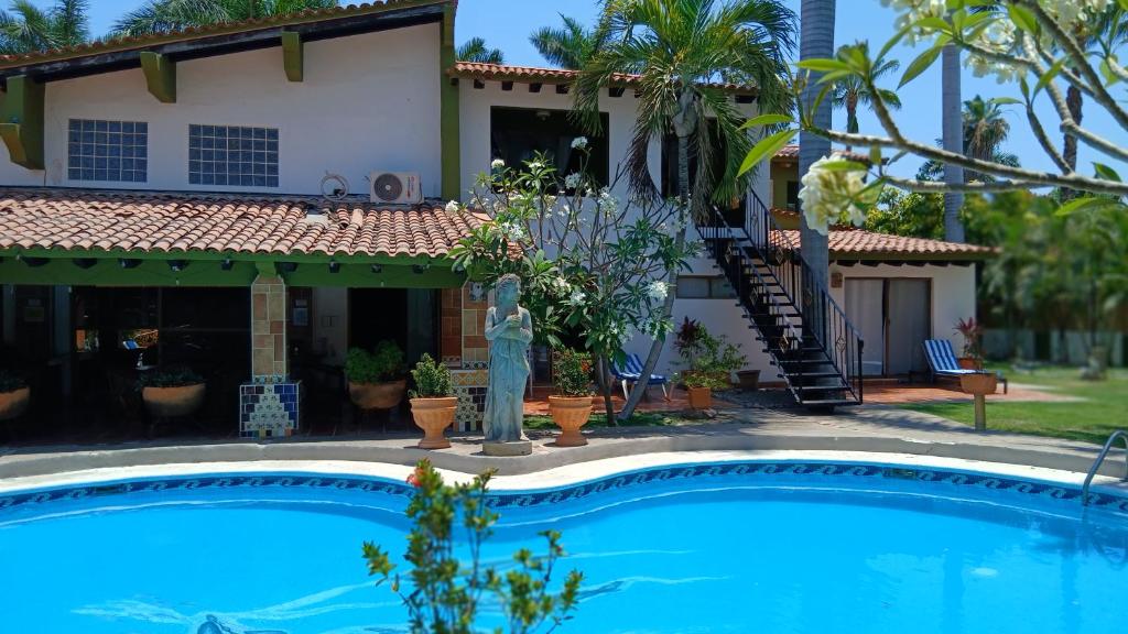 a house with a swimming pool in front of a house at Casa Virgilio B&B in Nuevo Vallarta