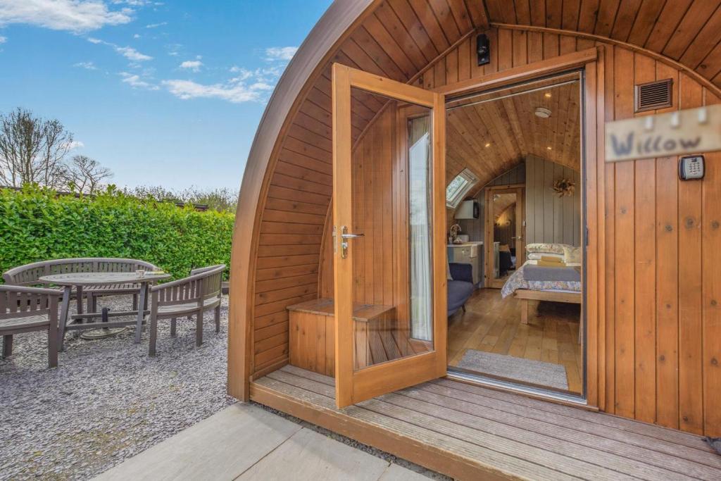 a small wooden building with a door and a bedroom at 1 Bed in Barnacre oc-w34347 in Catterall