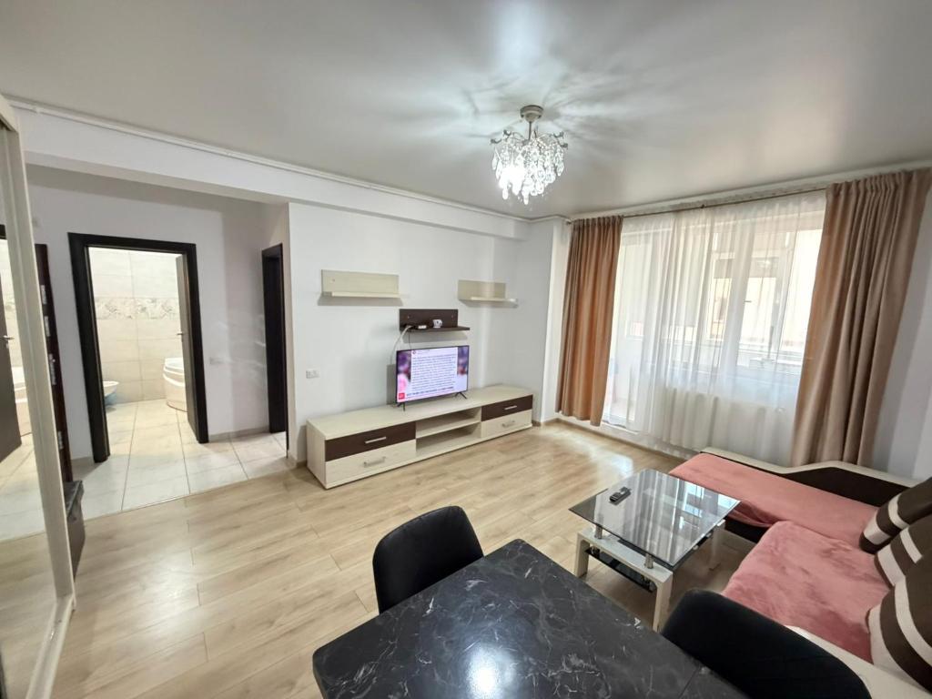 a living room with a couch and a tv at RC RelaxApart 602 in Dudu