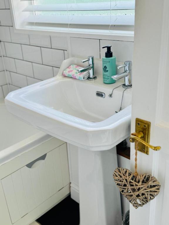 a white sink in a bathroom with a window at 31 Sailsbury road in Marlborough
