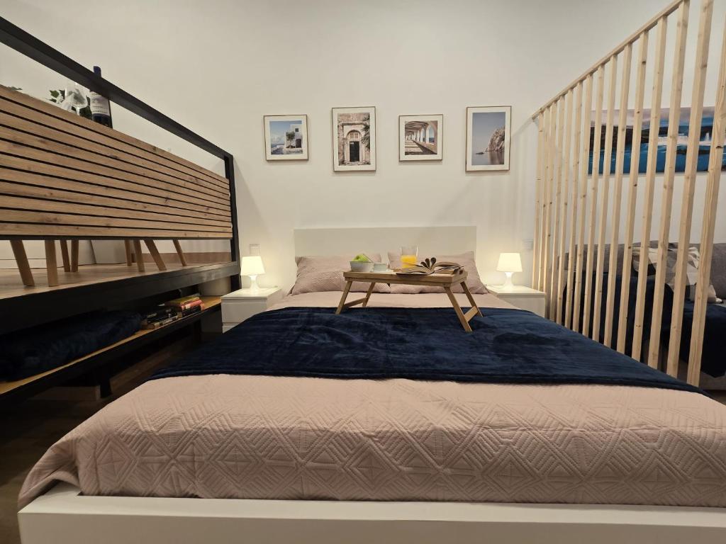 a bedroom with a bed with a table on it at Loft Centrico Tantín RH 17 in Santander
