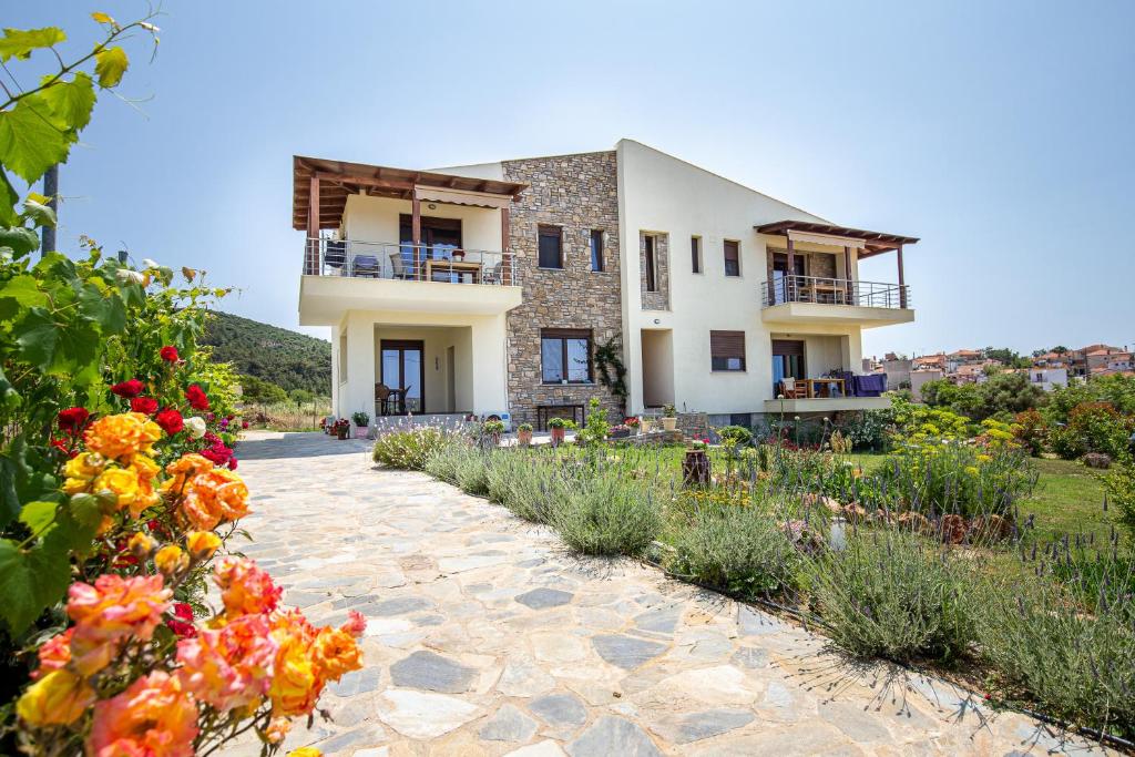 a house with flowers in front of it at House Rytha in Limenaria