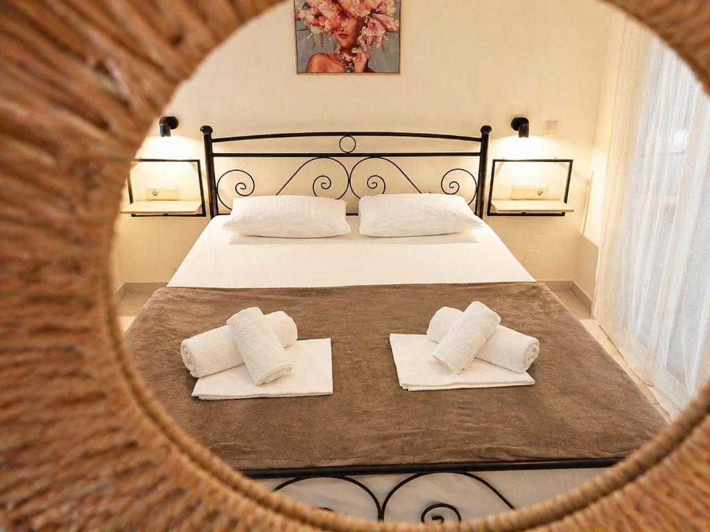 a bedroom with a bed with two white pillows at Joannas Luxury Apartment in Corfu