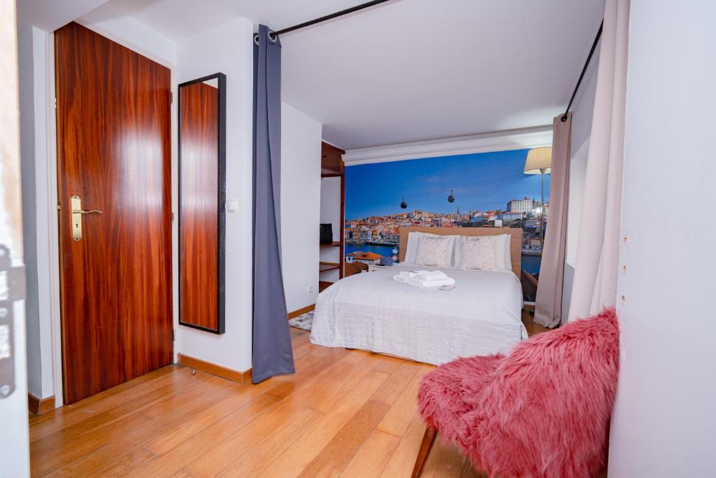 a bedroom with a bed and a view of a city at Large 1-Bedroom 1 Doble bed 1 Sofa bed 1 Bathroom Duplex Apartment Prime Lisbon Location in Lisbon