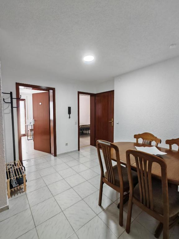 a dining room with a table and two chairs at Ferienwohnung Unterkunft 24 in Aldingen