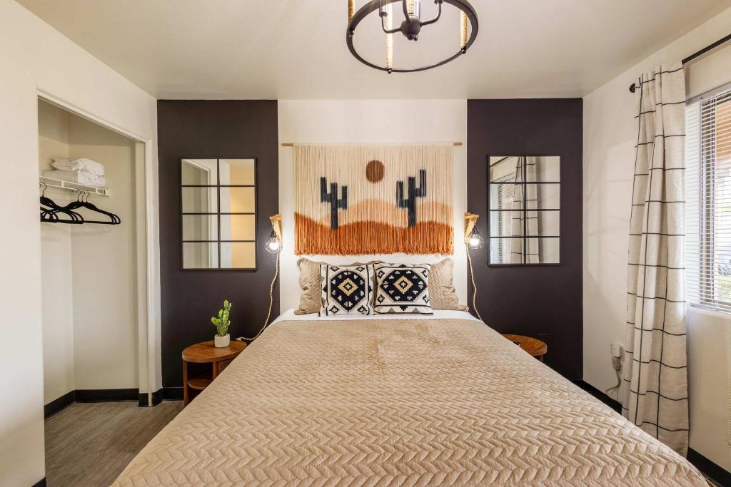 a bedroom with a large bed and a chandelier at Tolleson Studio Pool & Gym Access for 2 in Tolleson