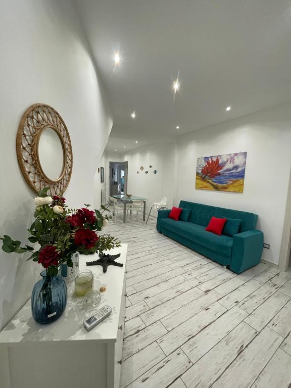 a living room with a blue couch and a table at Naxos Maréa Apartament in Giardini Naxos