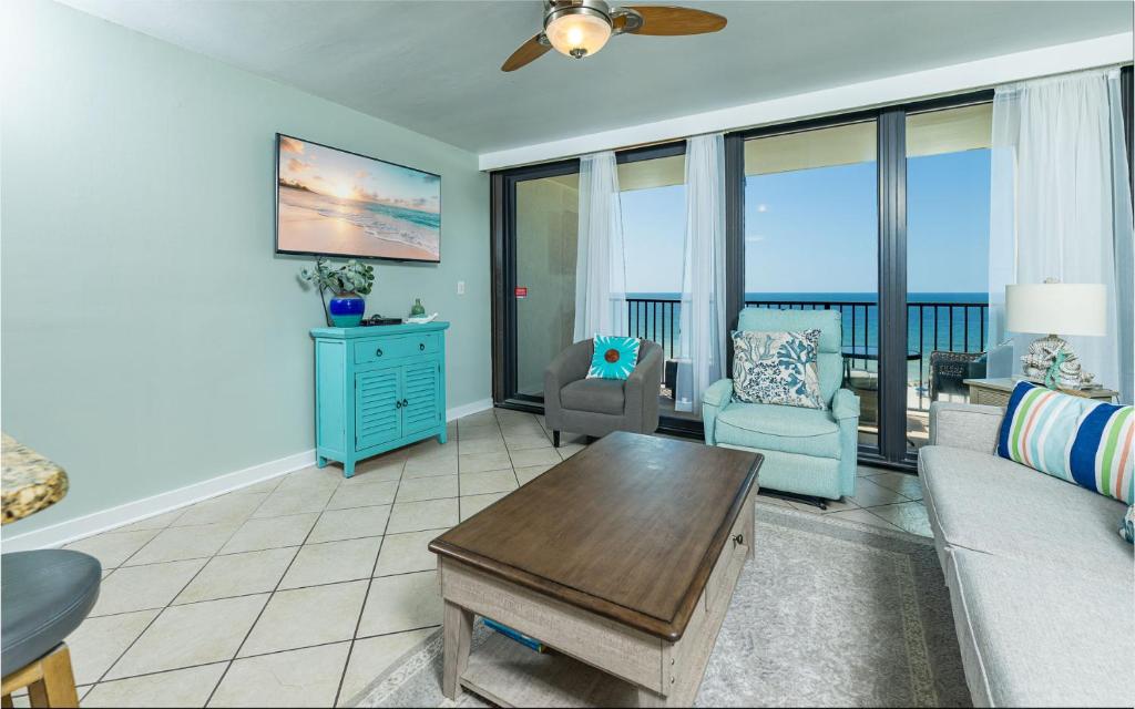 a living room with a couch and chairs and a table at Island Winds West 777 in Gulf Shores