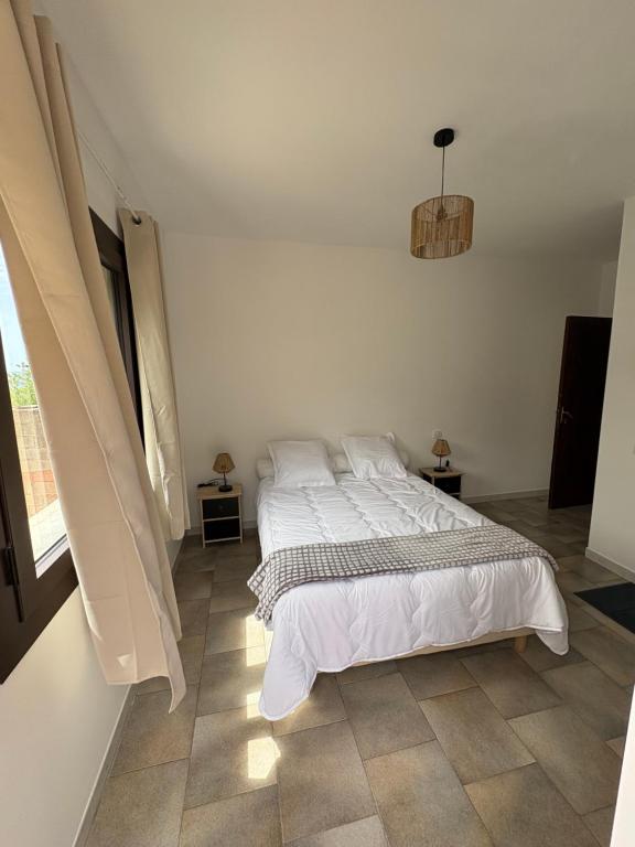 a bedroom with a large bed in a room at appartement olivese in Olivese