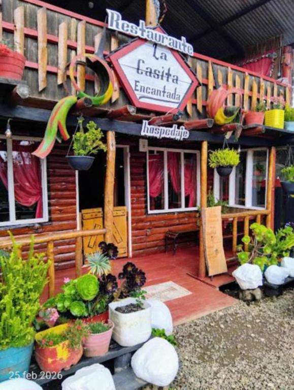 a restaurant with plants in front of a building at The Temple, Laguna de la Cocha in El Encano