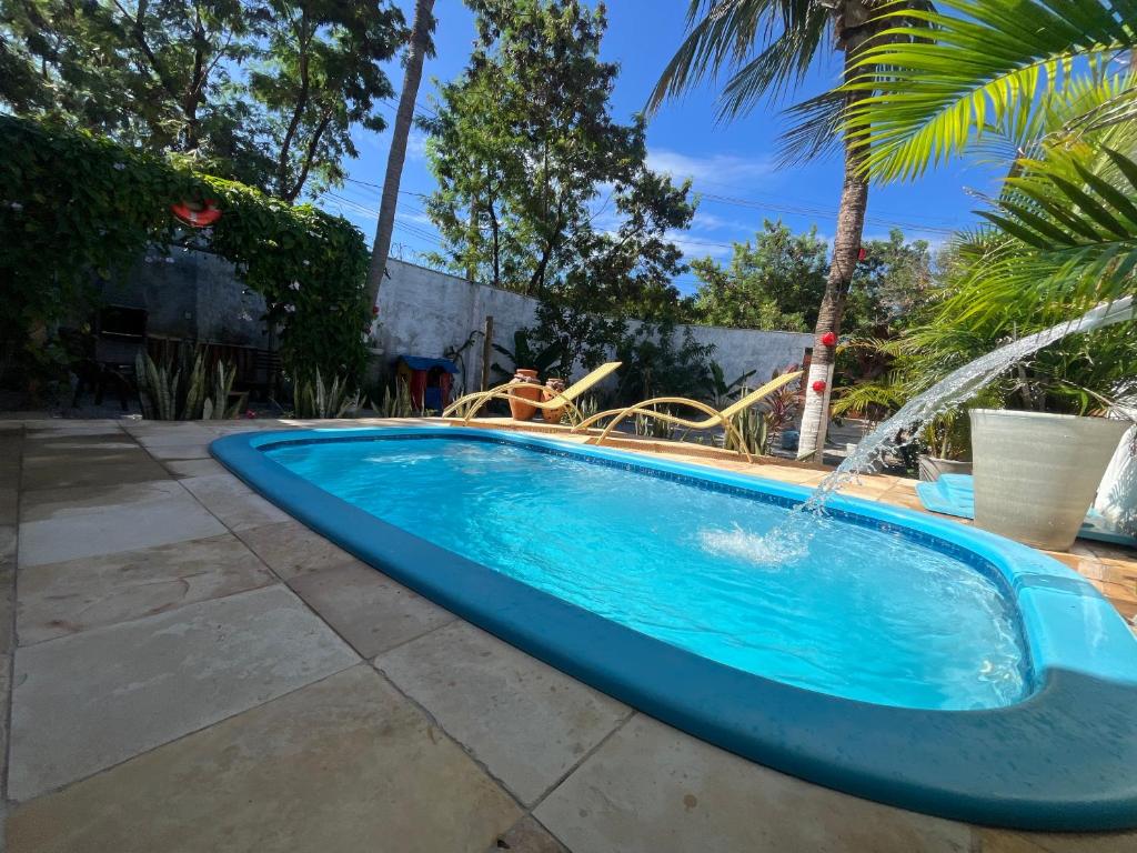 a swimming pool with a water slide at CASA DA PIPA in Pipa