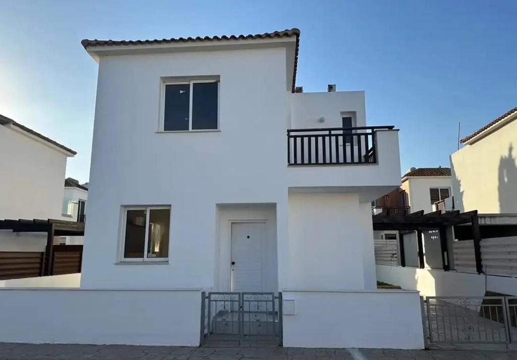 a white house with a balcony on the side at Villa Caesar in Ayia Napa