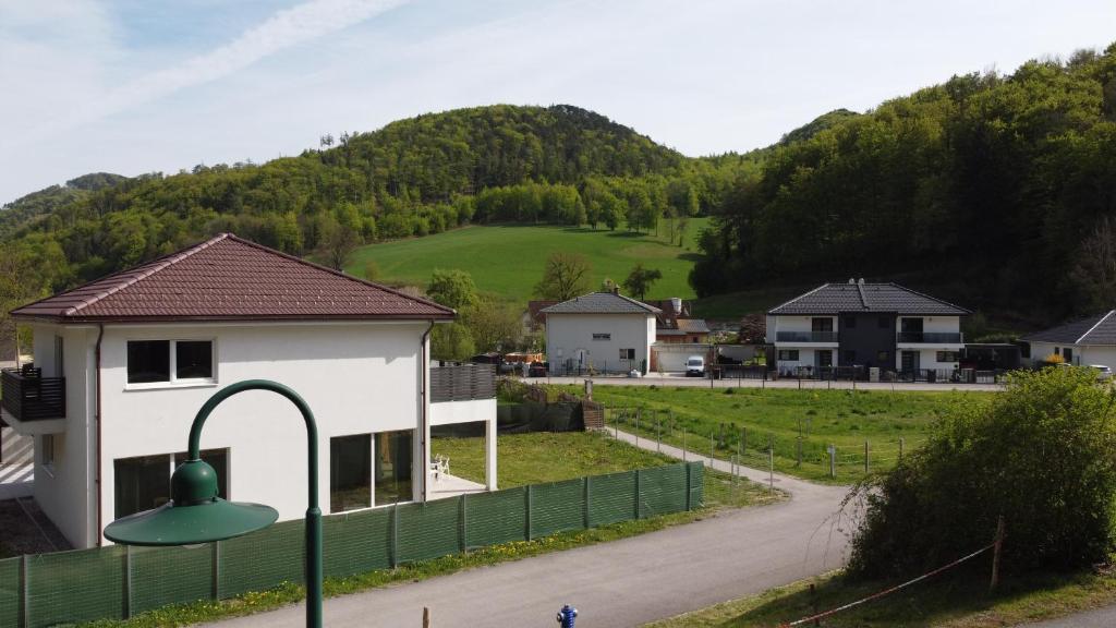 a building with a green fence and a street light at Das Haus in Furth an der Triesting