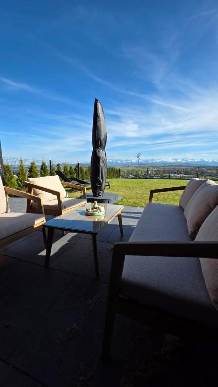 a living room with a couch and a table with a statue at Stodoły z Widokiem na Tatry in Nowy Targ