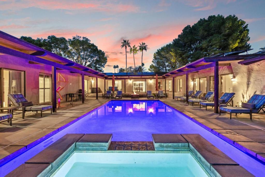 a swimming pool in the backyard of a house at Desert Solstice in Palm Springs