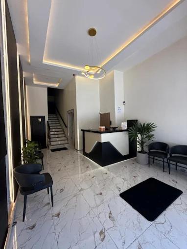 a lobby with chairs and a desk in a building at Hotel Milán in Cuenca