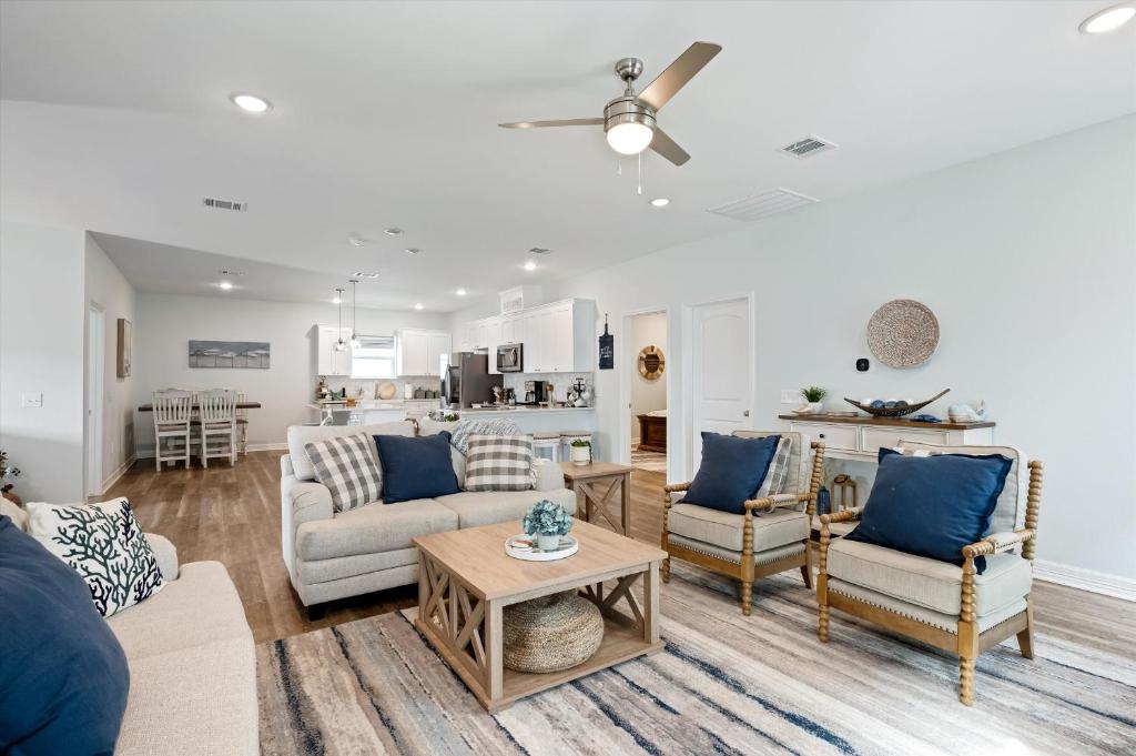 a living room with a couch and a table at Let's get Beachy! in Bolivar Peninsula