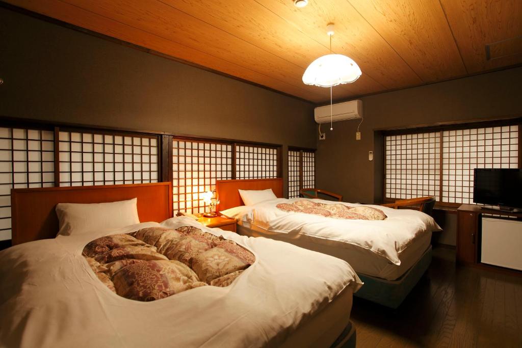 Ліжко або ліжка в номері Tagoto