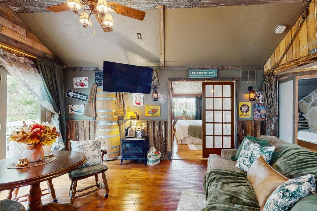 a living room with a couch and a table at Walk to Trails & Fishing Spots! Lake Ozark Escape in Four Seasons