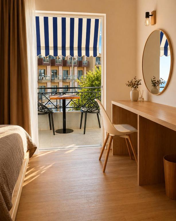 a bedroom with a bed and a desk and a window at Spilea Apartments in Himare