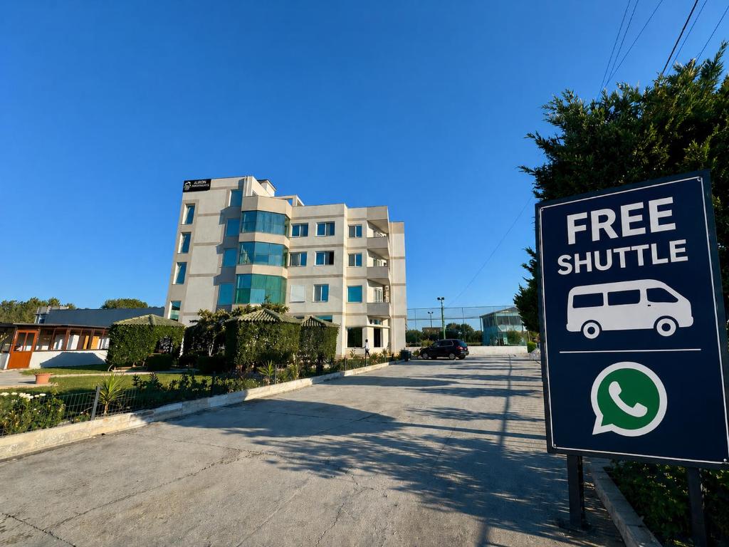 a free shuttle sign in front of a building at Aerostay hotel 1 km from airport in Rinas